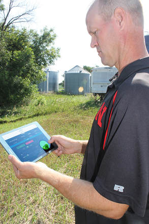 A grower uses his tablet to remotely monitor and control his irrigation systems.